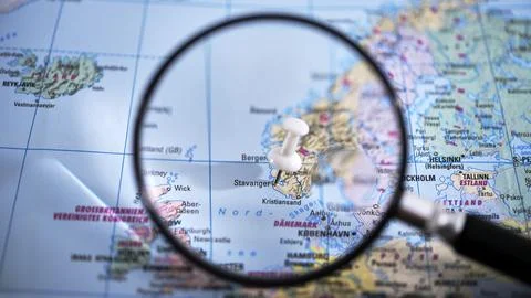 Stavanger marked on a printed map with a magnifying glass close-up Stock Photos