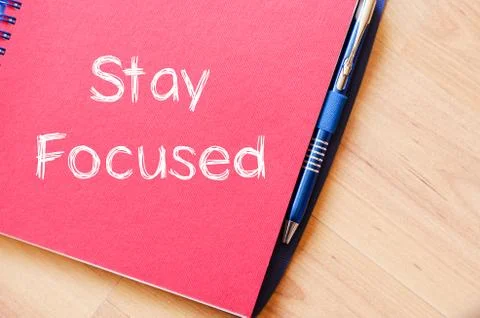 Stay focused concept on notebook Stock Photos