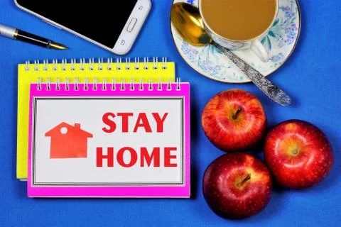 Stay at home-the text is written on a Notepad. Backed up by personal example. Stock Photos
