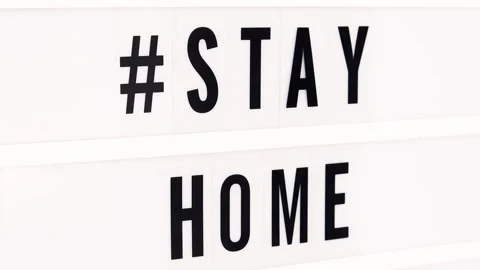 Stay Home written in a lightbox text. Quarantine and isolation. Covid-19. Stock Footage