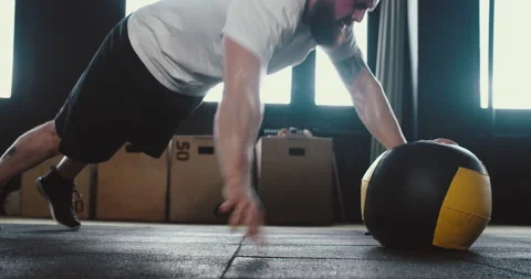 Staying fit. Side view young bearded muscular Caucasian sportsman doing push-ups Stock Footage 148548493
