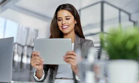 Staying organised with the most efficient tools. a young businesswoman working Stock Photos