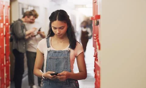 Staying in school is the smart thing to do. a teenage girl using a smartphone Stock Photos