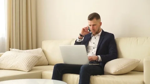 Staying in touch with colleagues. Handsome young man in shirt working on laptop Stock Footage 73899211