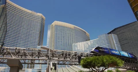 Steadicam Las Vegas Hotel Aria with a passing monorail Stock Footage