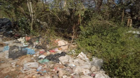 Steadicam motion of plastic and garbage by the side of the road in the Video stock 128813309