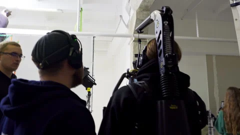 Steadicam operator walks carefully filming smooth test shots Видео 308951835