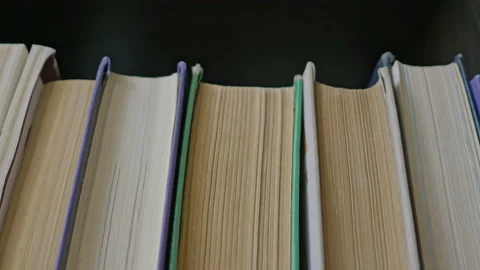 Steadicam shot, 4K. Camera gets closer to the stacked books on a book shelf Stock Footage 158210712