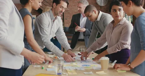 Steadicam shot in of creative diverse business team meeting Stock Footage