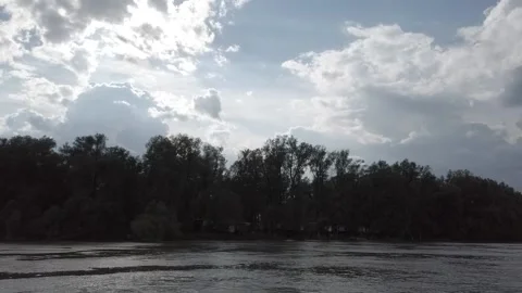 Steadicam shot from left side boat on the river with fishers huts on shore Stock Footage 164893361