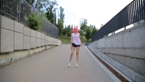 Steadicam shot of mixed race trendy hipster teenage girl walking wearing pink Stock Footage