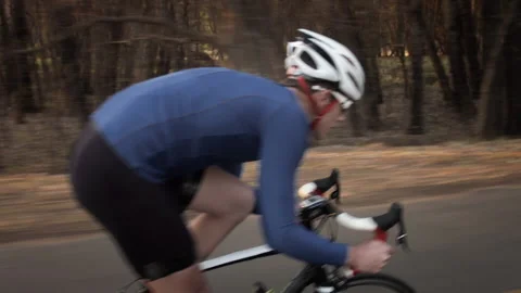 Steadicam shot of two healthy men peddling/ free wheeling with cycling road bicy Vidéo 199630916