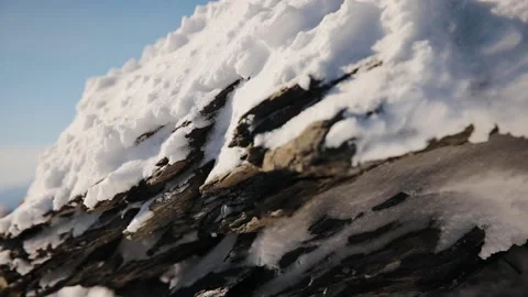 Steadicam stabilized shot of snowy rock in Swiss Alps. Rock mountain in winter Stock Footage 224744131