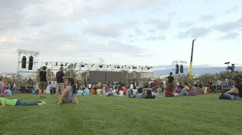 Steadicam tracking shot through a seated crowd at the music stage arena Stock Footage 54457732