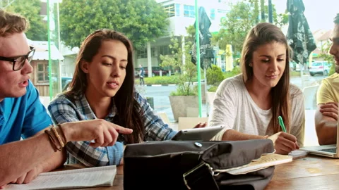 Steadicam/panning shot of young multicultural group of fellow creative students Stock Footage 199633593