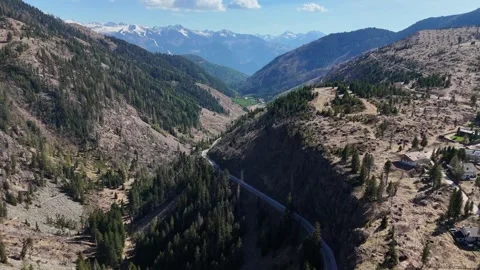 Steady Aerial Push Past Pine Forest Ridge Towards Snow Dusted Alpine Hor Stock Footage 339381255