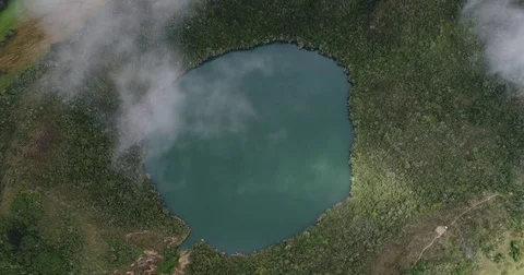 Steady aerial shot as the clouds pass over the Laguna de Guatavita Stock-Footage 77846541
