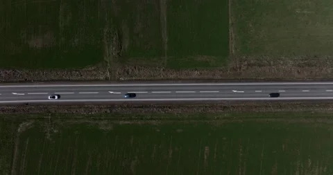 Steady aerial top-down shot of passing cars and trucks on a country road Stock Footage 201490607