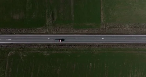 Steady aerial top-down shot of passing cars and trucks on a country road Video stock 201490631