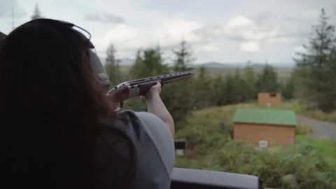 Steady, aim, fire as person raises shotgun and pulls trigger. Handheld Stock Footage 256068439