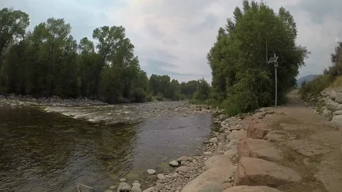 Steady cam shot down the path along the side of the river. Stock Footage 93383482