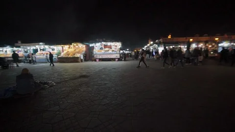 Steady cam shot of Jemaa el-Fnaa market stalls at night Stock Footage 100447265