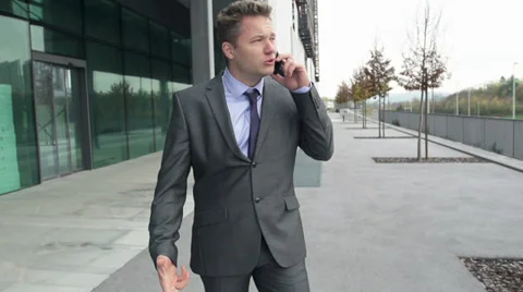 STEADY-CAM Slow Motion Of Dissatisfied Businessman Arguing On The Phone Stock Footage 35254252