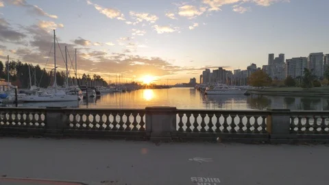 Steady camera paning over the sunrise ocean in Stanley park vancouver canada Stock Footage 96730213
