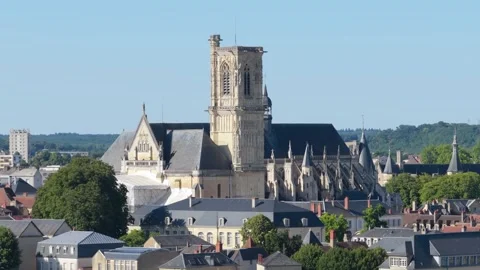 Steady daylight shot of Nevers Cathedral rising above the rooftops of Nevers Stock Footage 346718078