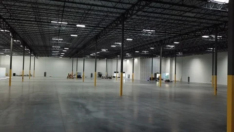 Steady drone shot inside of a brand new warehouse Stockbeeldmateriaal 100530595