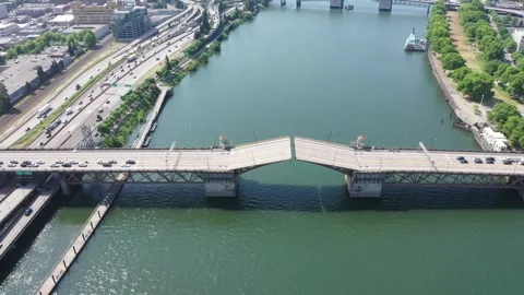 Steady flight above river Willamette with Burnside Bridge just closing bascule Stock Footage 244006014