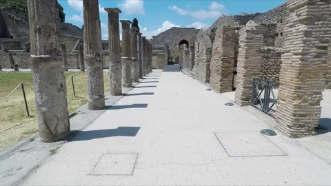 Steady glide between ancient columns of Pompeii, Italy Stock Footage 116453491