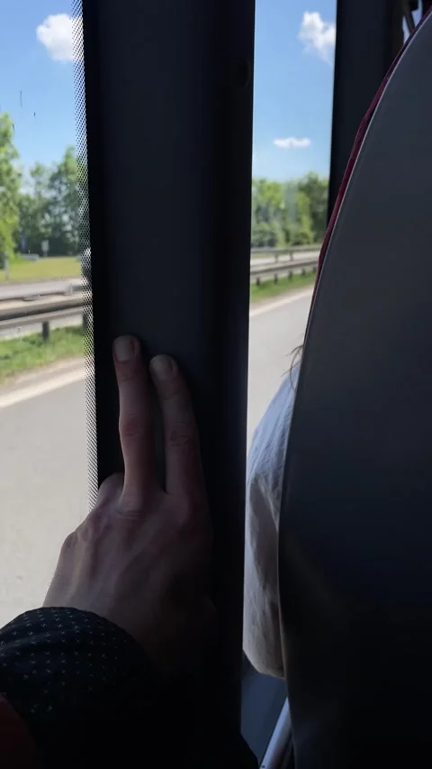 Steady hand on bus post captures transient moment amidst passing traffic Stock Footage 335368444
