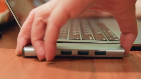 Steady hands connect USB hub to portable computer for work. Close view of hands Stock Footage 345524680