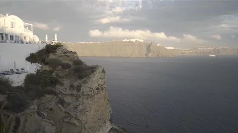 A steady medium shot form Oia, Santorini looking towards Thira at sunset Stock Footage 257671462