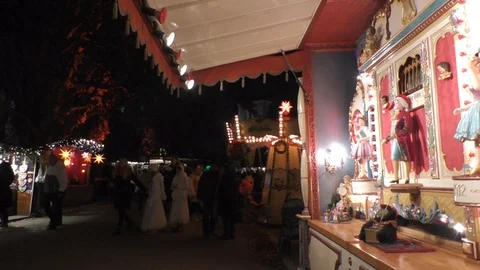 Steady night shot of walking crowd with fairground booth at Bueckeburger Chri Stock Footage 99540609