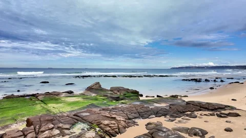 Steady Shot of Bar Beach with Ocean Waves and Rocks in Foreground. Stock Footage 313873287