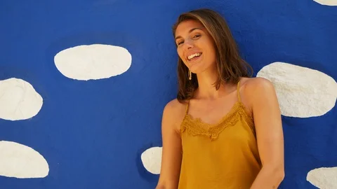 Steady Shot of Beautiful Model Posing in Front of Blue Wall Stock Footage 115846693