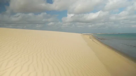 Steady shot on a big sand dune along the ocean, in Jericoacoara, Brazil Stock Footage 231558200