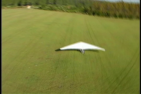 Steady shot of Hang Glider Floating Over Another Hang Glider Stock Footage