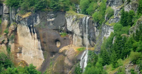 Steady shot of Powerful waterfall in mountain ridge Видео 62471836