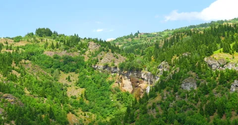 Steady shot of Powerful waterfall in mountain ridge Stock Footage 62471884