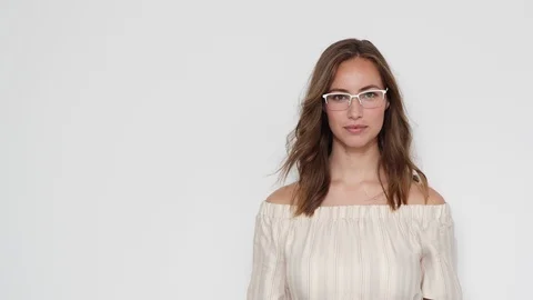 Steady Shot of Pretty Model Fixing Her Glasses and Smiles for the Camera 스톡 동영상 116915424