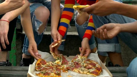 A steady shot shows a cooked mix pizza on a wooden plate while a pizza Group of Video stock 336586640