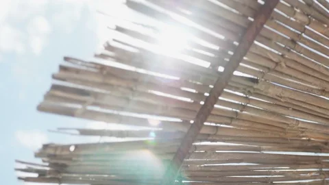 Steady shot of the sun's rays through the thatched roof Stock Footage 108676701