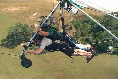 Steady Side Shot of Two People Hang Gliding and Turning to Landing Stock Footage 145063