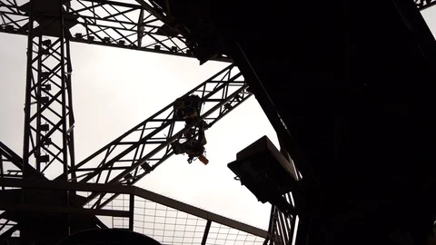 STEADY Silhouette of workers hanging from Eiffel Tower structure doing Stock Footage 109114060