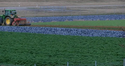 Steady slide of a tractor working on cabbage field Stock Footage 140302322