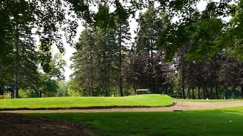 Steady Slow Motion Shot of Golf Course During Sunny Day Stock Footage 80390557