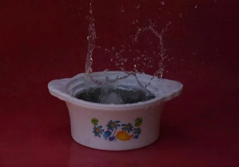 Steady splash in white container Stock Photos